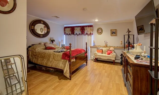 a bedroom with bed and a mirror