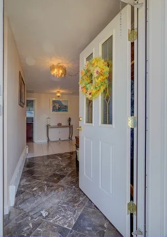 a view of a porch with furniture and floor to ceiling window
