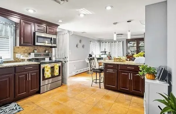 a kitchen with stainless steel appliances granite countertop sink stove and cabinets