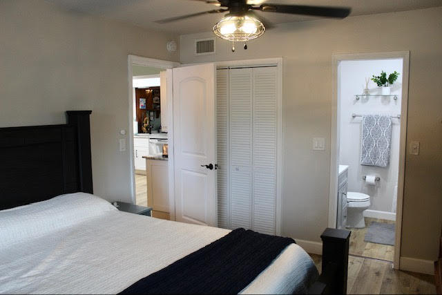 200 Lancaster Street Boca Raton, FL 33487 - Photo 28 of 43 a bedroom with a bed and a chandelier