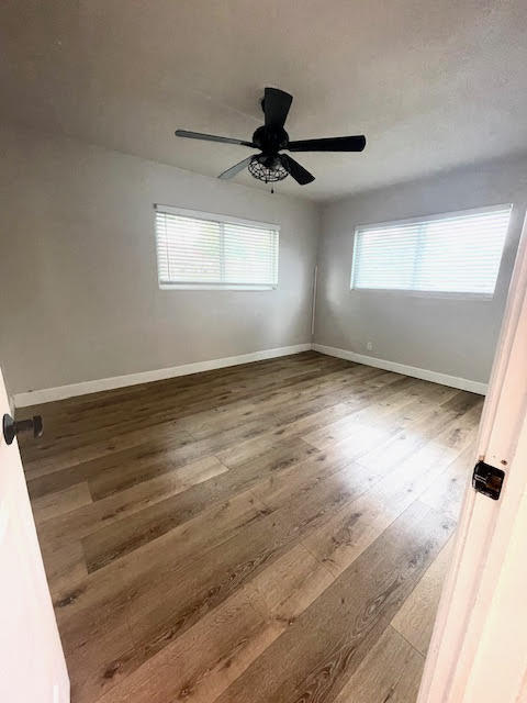 200 Lancaster Street Boca Raton, FL 33487 - Photo 30 of 43 an empty room with wooden floor cabinet and windows