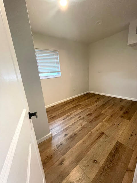 200 Lancaster Street Boca Raton, FL 33487 - Photo 34 of 43 an empty room with wooden floor