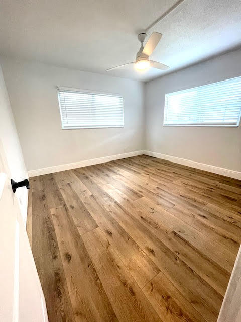 200 Lancaster Street Boca Raton, FL 33487 - Photo 38 of 43 an empty room with wooden floor fan and windows