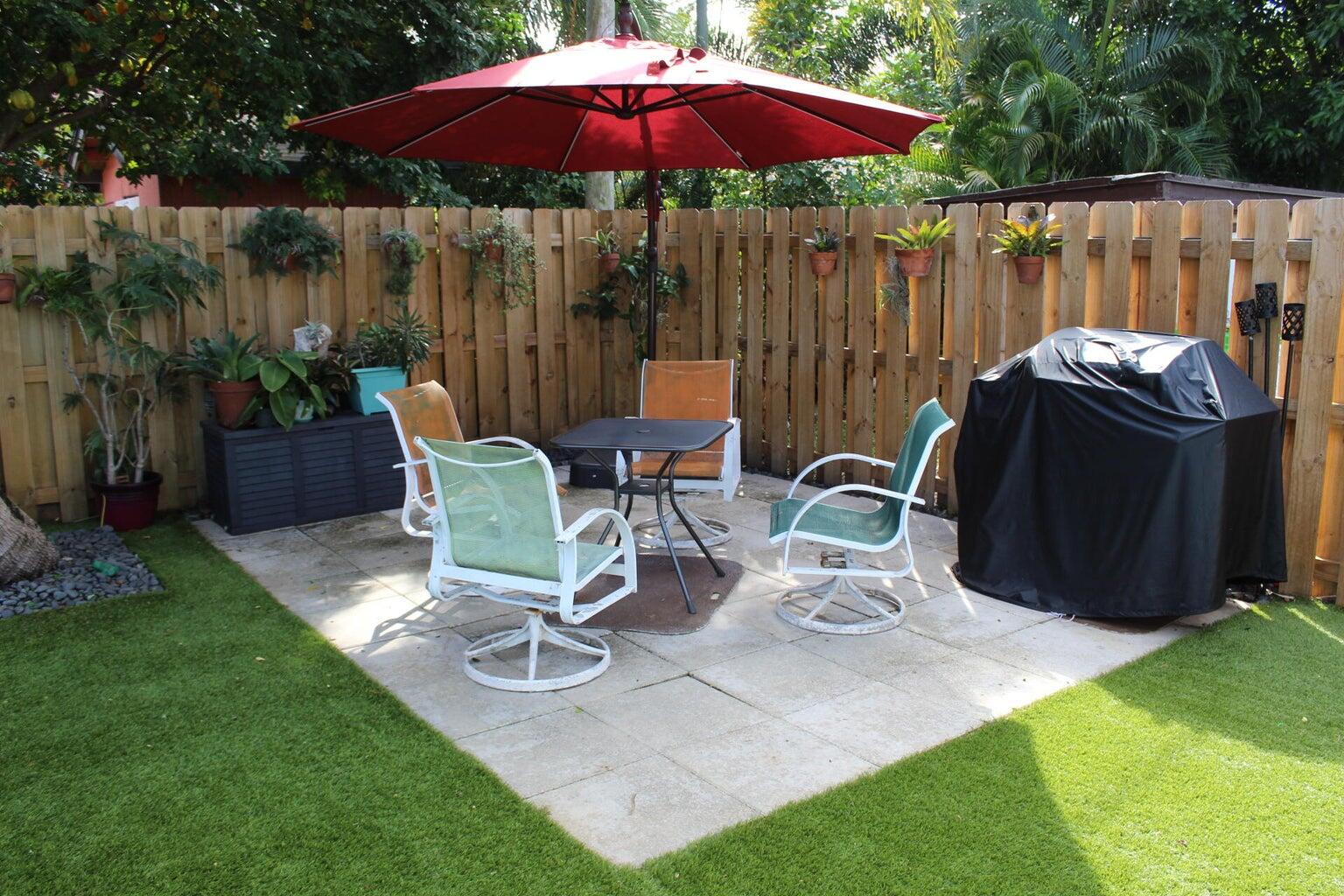200 Lancaster Street Boca Raton, FL 33487 - Photo 41 of 43 a view of a chairs and table in backyard