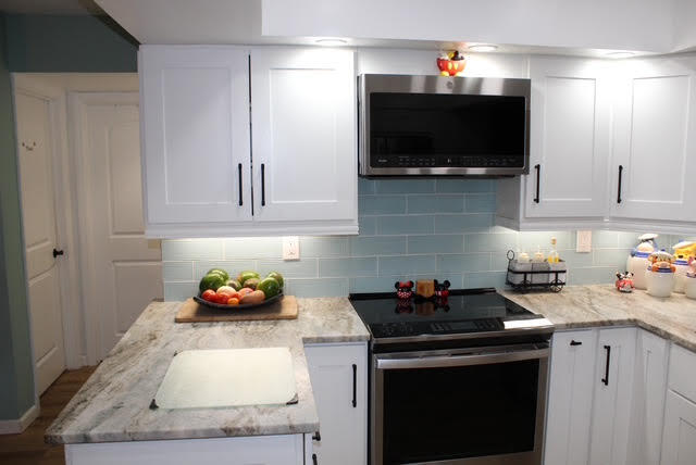 200 Lancaster Street Boca Raton, FL 33487 - Photo 8 of 43 a kitchen with stainless steel appliances a stove a microwave and cabinets