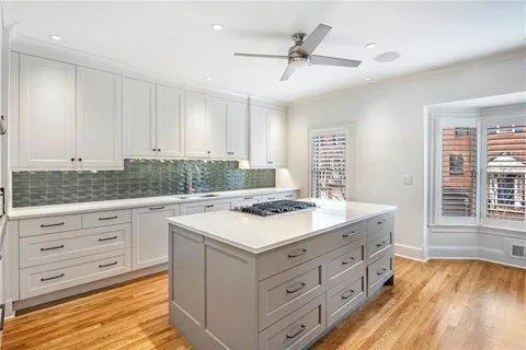 a kitchen with a stove a sink and a refrigerator
