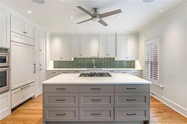 a bathroom with a granite countertop sink mirror vanity and bathtub