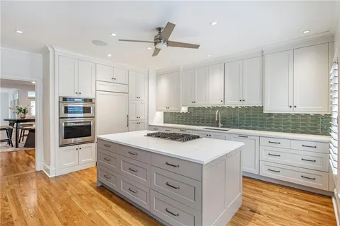 a kitchen with a stove a sink and a refrigerator