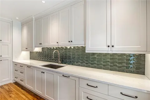 a kitchen with appliances cabinets and a counter top space