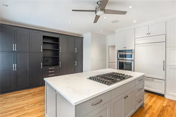 a kitchen with a refrigerator and a stove