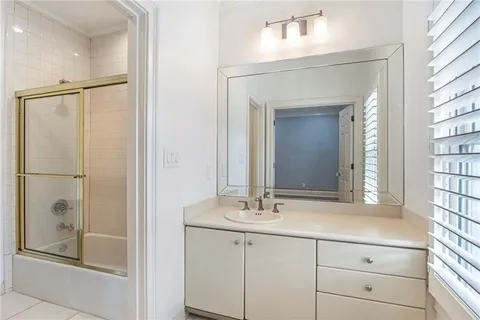 a bathroom with a shower sink and mirror