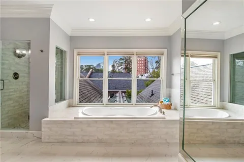 a living room with large window and a glass door shower