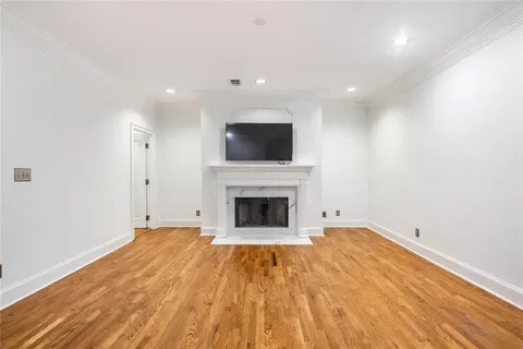a view of a livingroom with a fireplace a fireplace and wooden floor