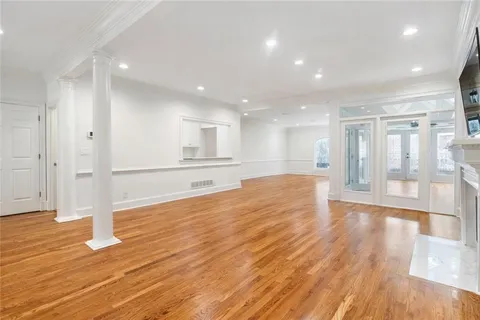 a view of a kitchen with wooden floor and a kitchen
