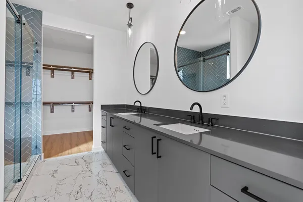 a bathroom with a double vanity sink and a mirror