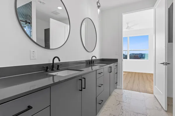 a bathroom with a double vanity sink and a mirror