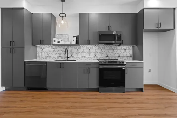 a kitchen with stainless steel appliances a sink stove and microwave