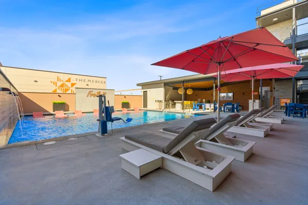 a view of a patio with a table and chairs under an umbrella