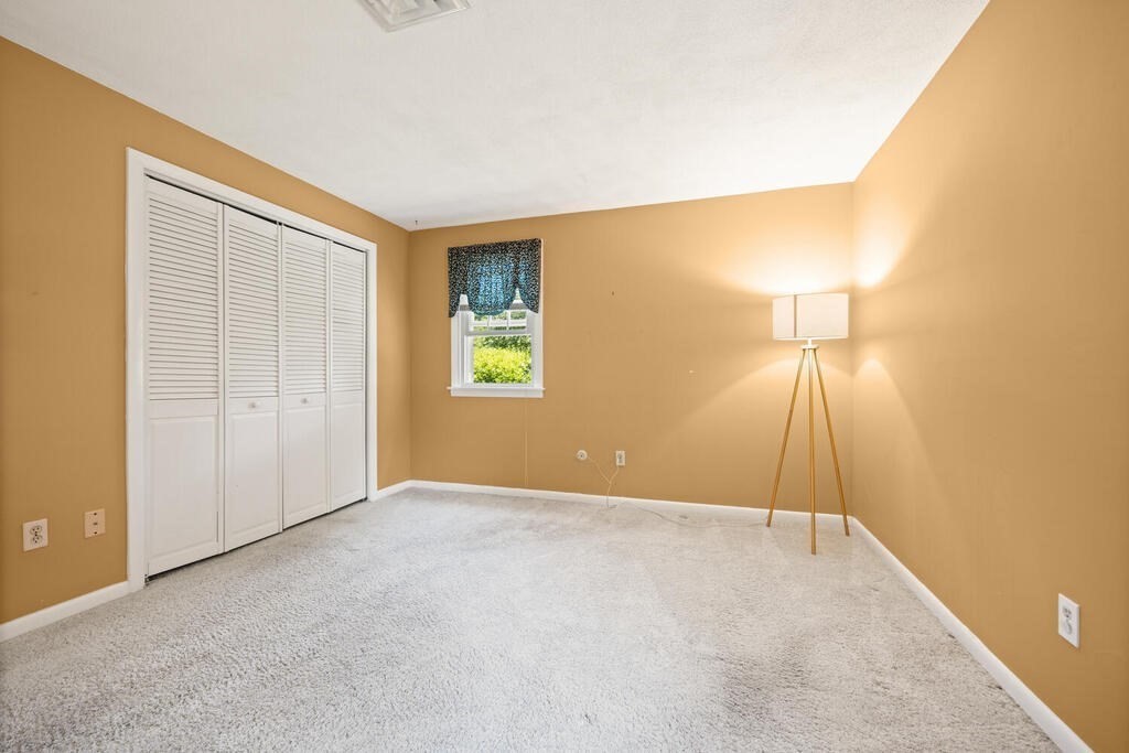 11 Rickey Drive Maynard, MA 01754 - Photo 11 of 29 a view of an empty room with a window