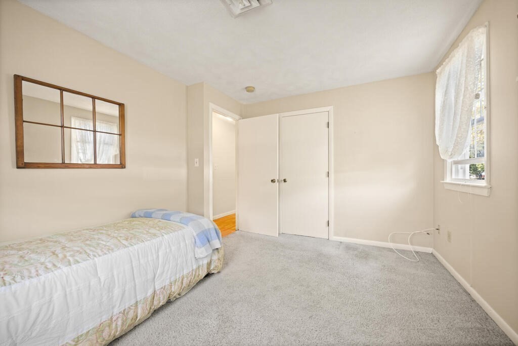 11 Rickey Drive Maynard, MA 01754 - Photo 14 of 29 a spacious bedroom with a bed and a window