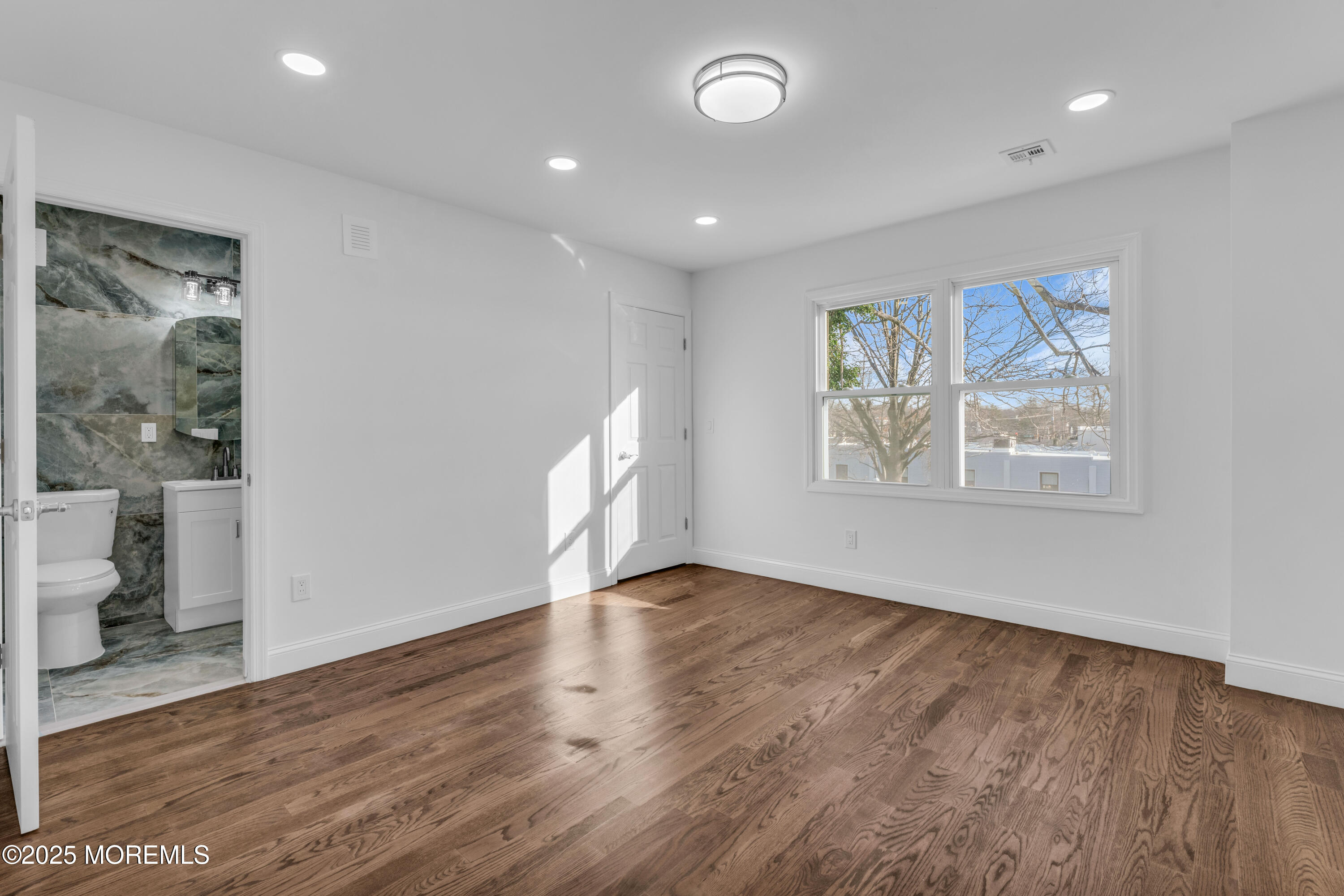 253 South Pearl Street, Unit B Red Bank, NJ 07701 - Photo 13 of 34 wooden floor in an empty room with a window