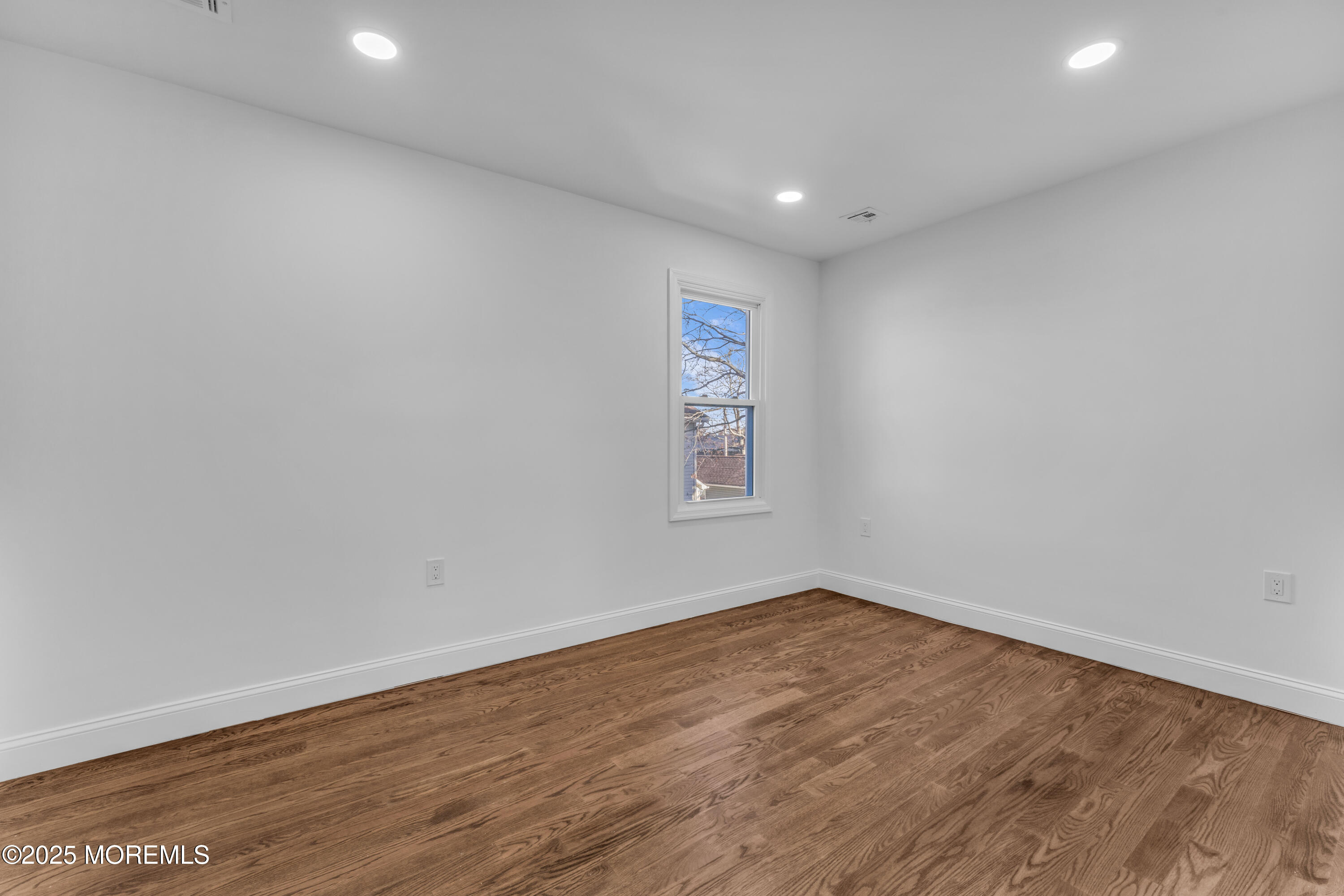 253 South Pearl Street, Unit B Red Bank, NJ 07701 - Photo 19 of 34 an empty room with wooden floor and windows