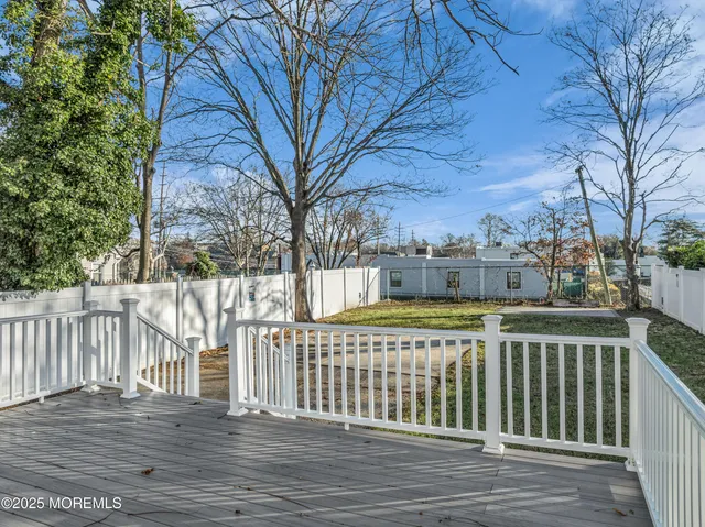 a view of a house with a wooden fence