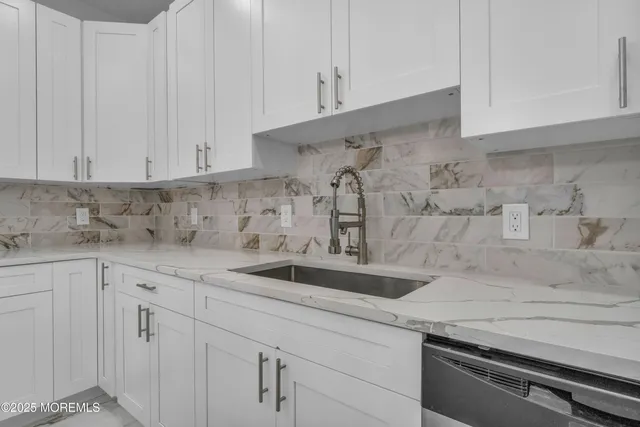 a kitchen with a sink and cabinets