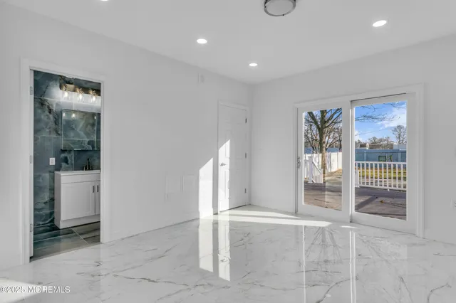 a view of a hallway with bathroom