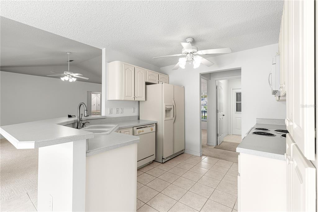 5312 Southwest 109th Place Road Ocala, FL 34476 - Photo 13 of 39 a kitchen with kitchen island a sink stainless steel appliances and cabinets