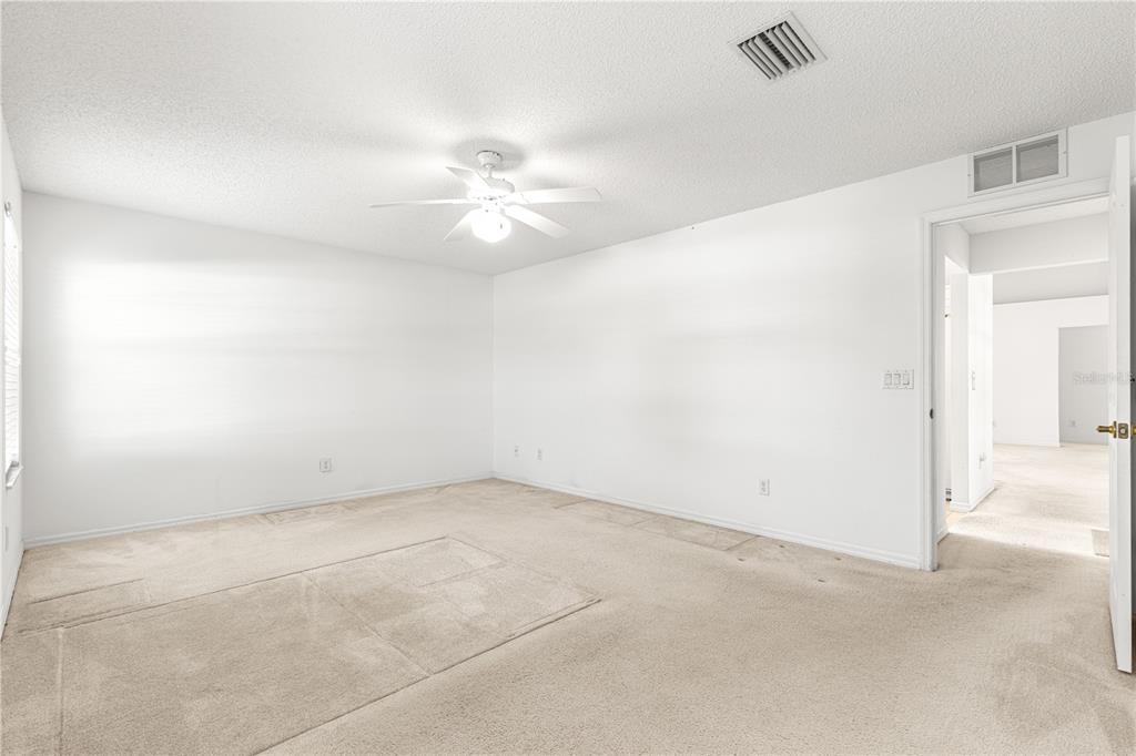 5312 Southwest 109th Place Road Ocala, FL 34476 - Photo 17 of 39 an empty room with chandelier fan