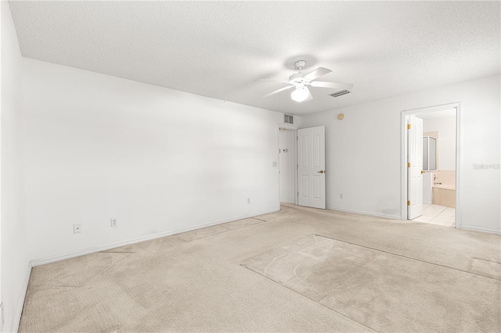 5312 Southwest 109th Place Road Ocala, FL 34476 - Photo 18 of 39 an empty room with fan and a ceiling fan