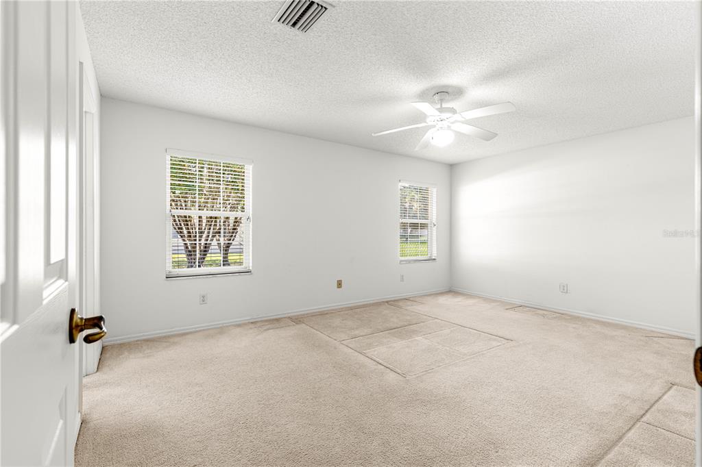 5312 Southwest 109th Place Road Ocala, FL 34476 - Photo 19 of 39 an empty room with windows and fan