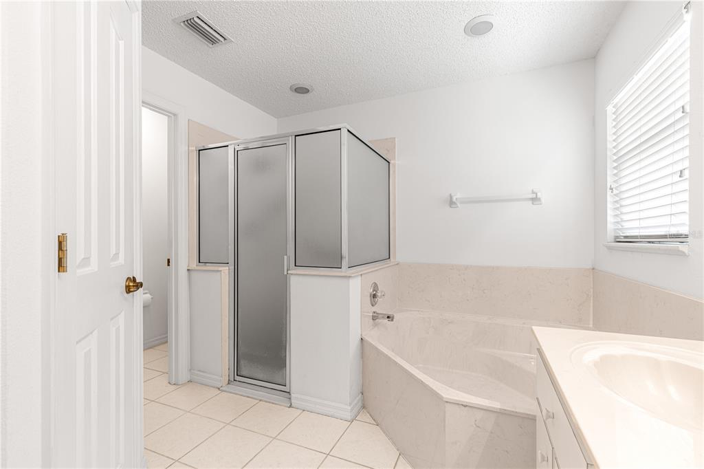 5312 Southwest 109th Place Road Ocala, FL 34476 - Photo 21 of 39 a bathroom with a bathtub and a shower