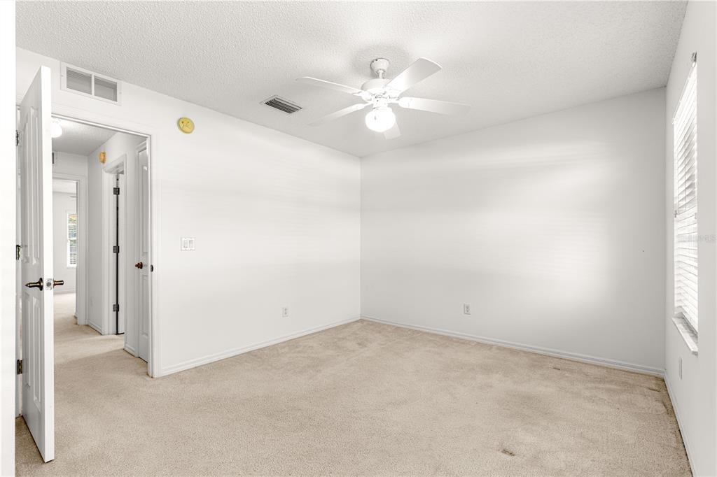 5312 Southwest 109th Place Road Ocala, FL 34476 - Photo 24 of 39 an empty room with chandelier fan and windows