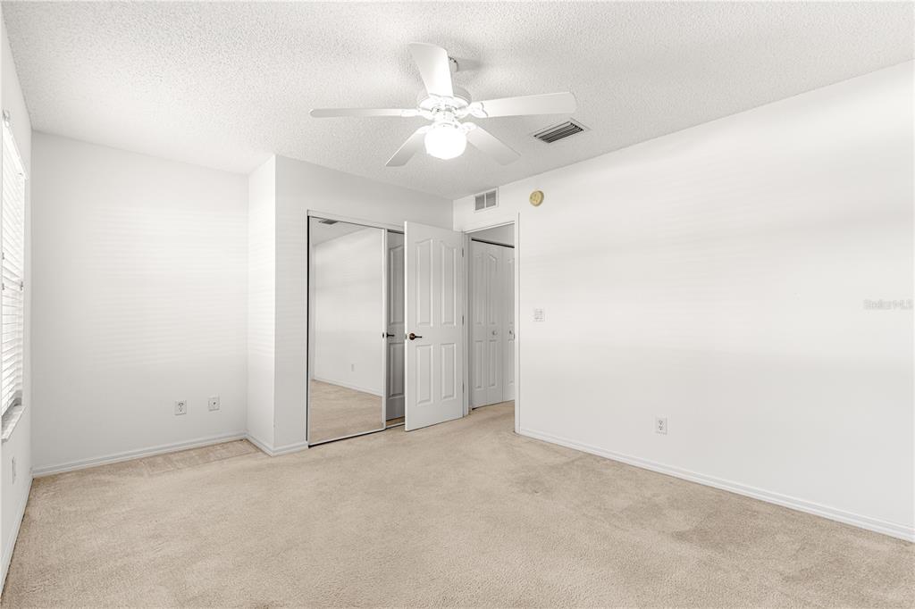 5312 Southwest 109th Place Road Ocala, FL 34476 - Photo 25 of 39 an empty room with a ceiling fan and a window