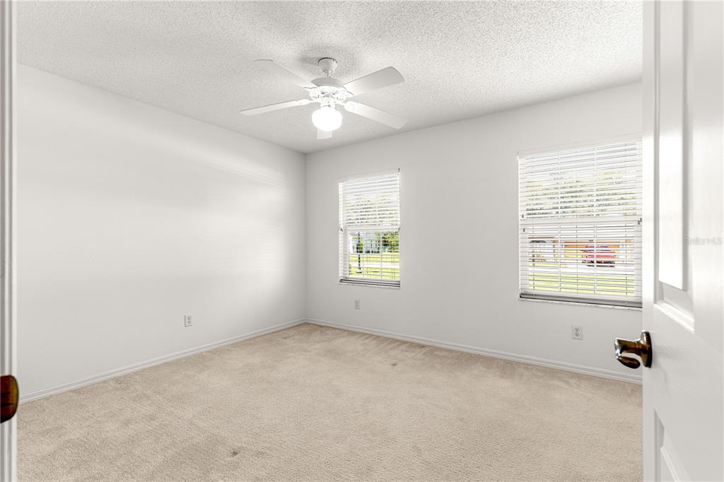 5312 Southwest 109th Place Road Ocala, FL 34476 - Photo 26 of 39 an empty room with windows and fan