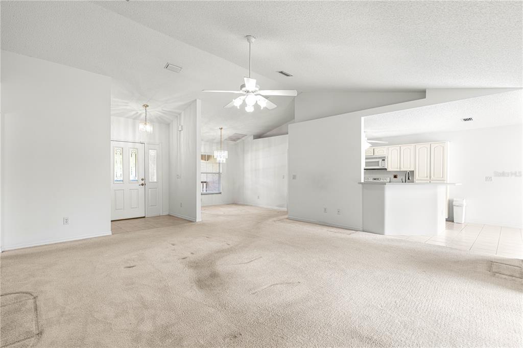 5312 Southwest 109th Place Road Ocala, FL 34476 - Photo 10 of 39 an empty room with kitchen and windows