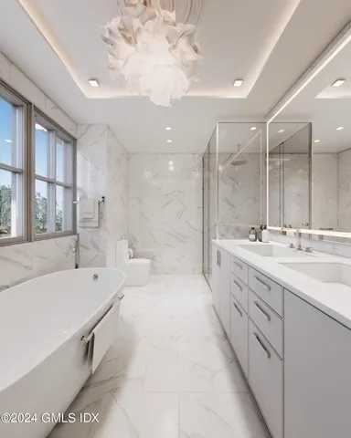 a large bathroom with a tub sink shower and mirror