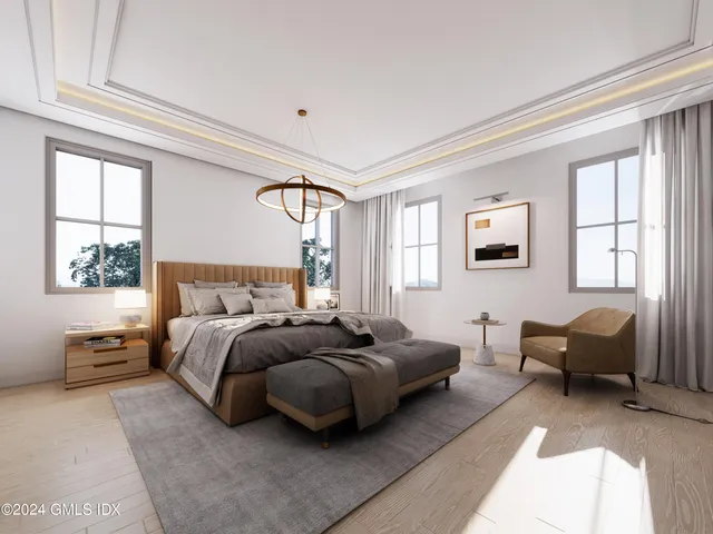 a bedroom with a bed couch and window