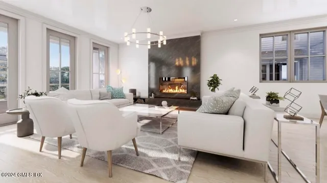 a living room with furniture and a chandelier