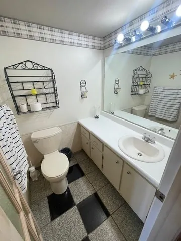 a view of a hallway with paintings on the wall