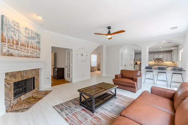 a living room with furniture and a fireplace