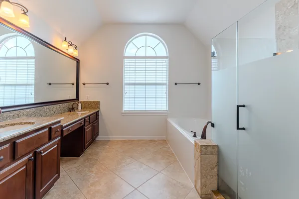 a large bathroom with a granite countertop sink and a mirror