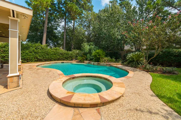 a view of a swimming pool with a yard