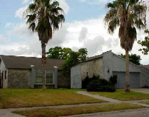 a front view of a house with a garden and yard