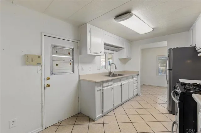 a kitchen with stainless steel appliances a refrigerator sink and cabinets