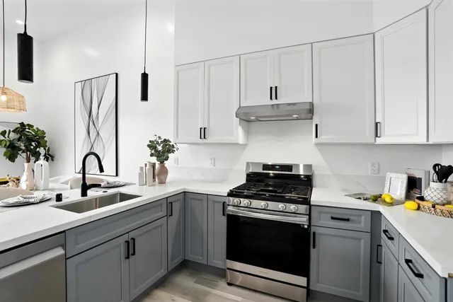 a kitchen with appliances a sink and cabinets