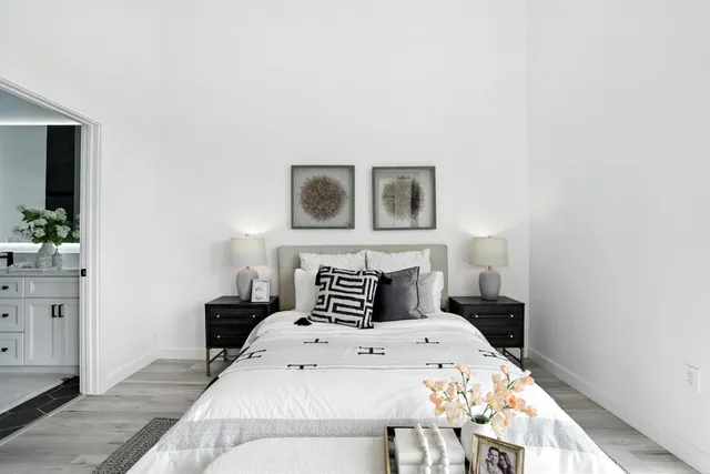 a bedroom with a bed and a chandelier