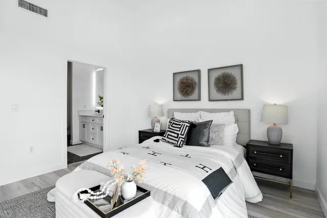 a bedroom with a bed and a night stand